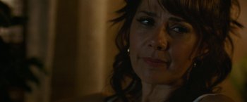 Movie still from “The King of Staten Island” (2020), directed by Judd Apatow – A woman's face in a dimly - lit room; Close Up shot, Over the shoulder angle