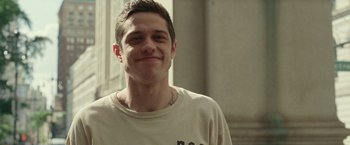 Movie still from “The King of Staten Island” (2020), directed by Judd Apatow – A man with a tattoo is posing for a picture; Close Up shot, Over the shoulder angle