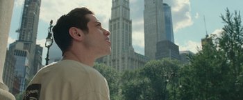 Movie still from “The King of Staten Island” (2020), directed by Judd Apatow – A man standing in front of a tall building; Close Up shot, Low angle