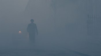 Movie still from “The King's Speech” (2010), directed by Tom Hooper – A man walking in the fog on a street; Wide shot, Low angle