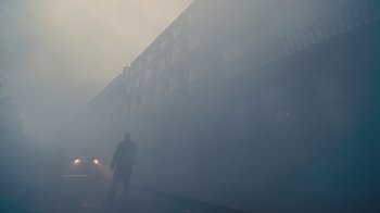 Movie still from “The King's Speech” (2010), directed by Tom Hooper – A man standing in front of a building in the fog; Extreme Wide shot, Low angle