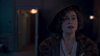 Movie still from “The King's Speech” (2010), directed by Tom Hooper – A woman in a hat and a coat; Close Up shot, Over the shoulder angle