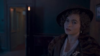 Movie still from “The King's Speech” (2010), directed by Tom Hooper – A woman wearing a hat and a fur coat; Close Up shot, Over the shoulder angle