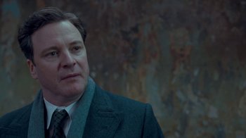 Movie still from “The King's Speech” (2010), directed by Tom Hooper – A person wearing a suit and tie; Close Up shot, Over the shoulder angle