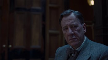 Movie still from “The King's Speech” (2010), directed by Tom Hooper – An older man wearing a suit and a bow tie; Close Up shot, Low angle