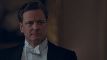Movie still from “The King's Speech” (2010), directed by Tom Hooper – A person wearing a suit and bow tie; Close Up shot, Low angle