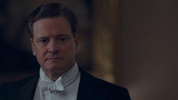 Movie still from “The King's Speech” (2010), directed by Tom Hooper – A person wearing a suit and bow tie; Close Up shot, Low angle