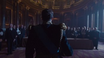 Movie still from “The King's Speech” (2010), directed by Tom Hooper – A man in a uniform standing in front of a group of people; Wide shot, Low angle