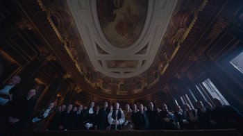 Movie still from “The King's Speech” (2010), directed by Tom Hooper – A large group of people standing under a ceiling; Extreme Wide shot, Low angle