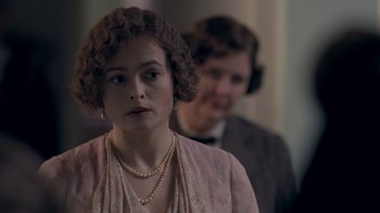 Movie still from “The King's Speech” (2010), directed by Tom Hooper – A woman in a pink dress and a man in a brown suit; Close Up shot, Over the shoulder angle