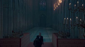 Movie still from “The King's Speech” (2010), directed by Tom Hooper – A man in a suit standing in the middle of an aisle of a church; Extreme Wide shot, High angle