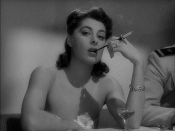 Movie still from “The Lady Eve” (1941), directed by Preston Sturges – A black - and - white photo of a woman smoking a cigarette; Close Up shot, Low angle