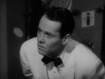 Movie still from “The Lady Eve” (1941), directed by Preston Sturges – A black and white photo of a man wearing a suit and bow tie; Close Up shot, Low angle
