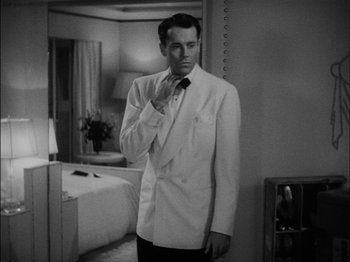 Movie still from “The Lady Eve” (1941), directed by Preston Sturges – A black and white photo of a man in a white suit; Medium shot, Over the shoulder angle