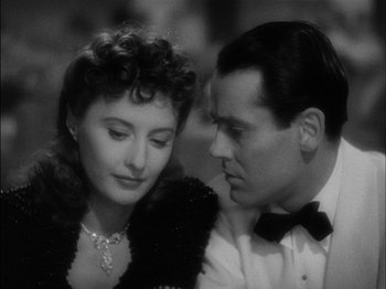 Movie still from “The Lady Eve” (1941), directed by Preston Sturges – A man and a woman sitting next to each other in front of each other; Close Up shot, Over the shoulder angle