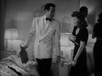 Movie still from “The Lady Eve” (1941), directed by Preston Sturges – A man and a woman standing in front of each other; Medium shot, High angle