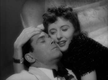 Movie still from “The Lady Eve” (1941), directed by Preston Sturges – A man and a woman are kissing in a black - and - white photo; Close Up shot, Overhead angle
