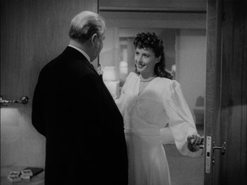 Movie still from “The Lady Eve” (1941), directed by Preston Sturges – An older man standing next to a young woman in a room; Medium shot, Over the shoulder angle