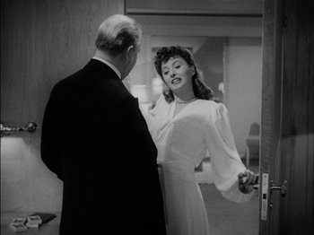 Movie still from “The Lady Eve” (1941), directed by Preston Sturges – An older man standing next to a young woman; Medium shot, Over the shoulder angle