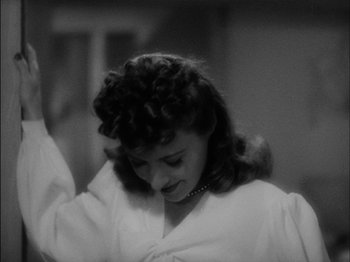 Movie still from “The Lady Eve” (1941), directed by Preston Sturges – A black - and - white photo of a woman in a robe; Close Up shot, High angle