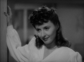 Movie still from “The Lady Eve” (1941), directed by Preston Sturges – An old black and white photo of a woman waving; Close Up shot, Over the shoulder angle