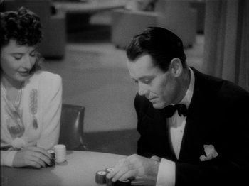 Movie still from “The Lady Eve” (1941), directed by Preston Sturges – A black and white photo of a man and a woman at a table; Medium shot, High angle
