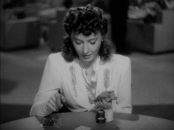 Movie still from “The Lady Eve” (1941), directed by Preston Sturges – A black and white photo of a woman playing cards; Close Up shot, High angle