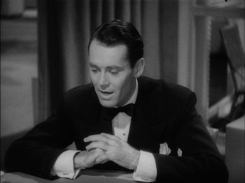 Movie still from “The Lady Eve” (1941), directed by Preston Sturges – A black and white photo of a man in a tuxedo; Close Up shot, High angle