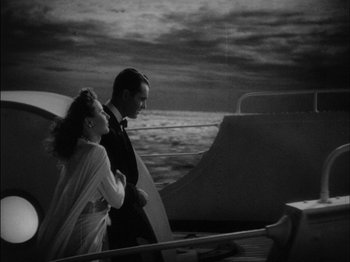 Movie still from “The Lady Eve” (1941), directed by Preston Sturges – A black and white photo of a man and a woman on a boat; Medium shot, High angle