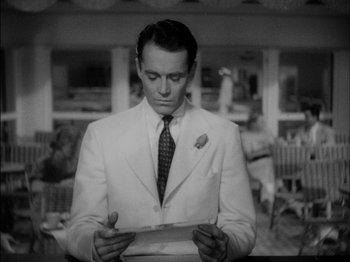 Movie still from “The Lady Eve” (1941), directed by Preston Sturges – A black and white photo of a man in a white suit; Medium shot, Low angle