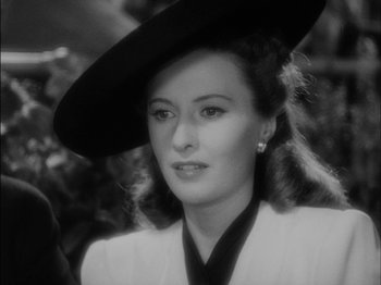Movie still from “The Lady Eve” (1941), directed by Preston Sturges – A black and white photo of a woman wearing a hat; Close Up shot, Over the shoulder angle