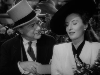 Movie still from “The Lady Eve” (1941), directed by Preston Sturges – An older man wearing a hat and a woman wearing a hat; Close Up shot, Over the shoulder angle