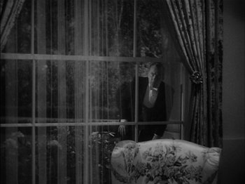Movie still from “The Lady Eve” (1941), directed by Preston Sturges – A woman sitting on a chair looking out of a window; Wide shot, High angle