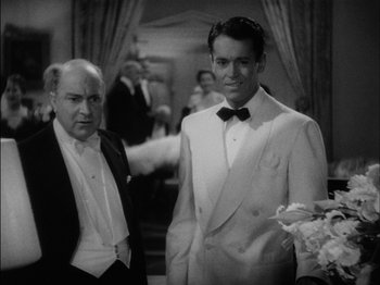 Movie still from “The Lady Eve” (1941), directed by Preston Sturges – Two men in tuxedos standing next to each other; Medium shot, High angle