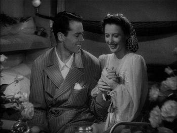 Movie still from “The Lady Eve” (1941), directed by Preston Sturges – A man and a woman are holding a cat; Medium shot, High angle