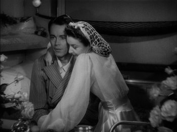 Movie still from “The Lady Eve” (1941), directed by Preston Sturges – A man and a woman sitting at a dinner table; Medium shot, High angle