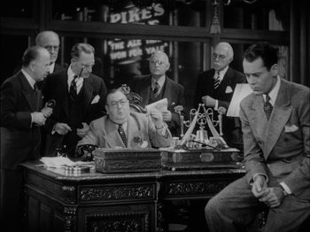 Movie still from “The Lady Eve” (1941), directed by Preston Sturges – A group of men sitting at a table; Medium shot, Low angle