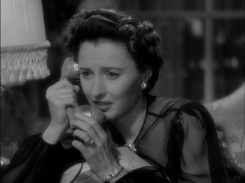 Movie still from “The Lady Eve” (1941), directed by Preston Sturges – An old photo of a woman talking on a phone; Close Up shot, High angle