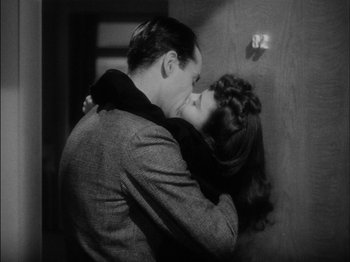 Movie still from “The Lady Eve” (1941), directed by Preston Sturges – A man and a woman kissing in a room; Close Up shot, High angle