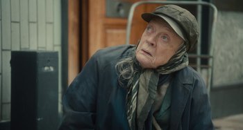 Movie still from “The Lady in the Van” (2015), directed by Nicholas Hytner – An older woman wearing a hat and a jacket; Close Up shot, Over the shoulder angle
