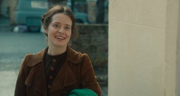 Movie still from “The Lady in the Van” (2015), directed by Nicholas Hytner – A young woman smiles while holding a green towel; Close Up shot, Over the shoulder angle