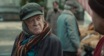 Movie still from “The Lady in the Van” (2015), directed by Nicholas Hytner – An older woman wearing a hat and a scarf; Close Up shot, Over the shoulder angle