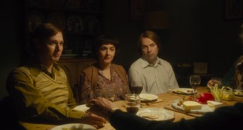 Movie still from “The Lady in the Van” (2015), directed by Nicholas Hytner – A group of people sitting at a dinner table; Medium shot, High angle