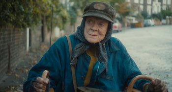 Movie still from “The Lady in the Van” (2015), directed by Nicholas Hytner – An old woman is holding an umbrella in the rain; Close Up shot, Over the shoulder angle