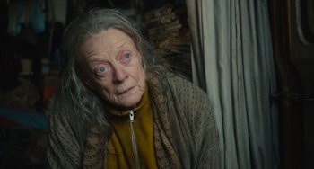 Movie still from “The Lady in the Van” (2015), directed by Nicholas Hytner – An old woman with long grey hair looking at the camera; Close Up shot, Low angle