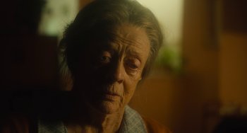 Movie still from “The Lady in the Van” (2015), directed by Nicholas Hytner – An older woman with a sad look on her face; Close Up shot, Over the shoulder angle