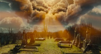 Movie still from “The Lady in the Van” (2015), directed by Nicholas Hytner – Two people are standing in a graveyard under a cloudy sky; Extreme Wide shot, Low angle