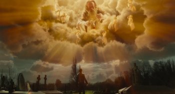 Movie still from “The Lady in the Van” (2015), directed by Nicholas Hytner – A man standing in front of a cloud filled sky; Extreme Wide shot, Low angle