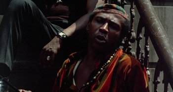 Movie still from “The Landlord” (1970), directed by Hal Ashby – A man in a colorful shirt is getting his hair combed; Close Up shot, Low angle