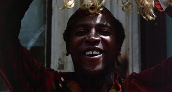 Movie still from “The Landlord” (1970), directed by Hal Ashby – A person smiling with a bunch of spaghetti hanging on their head; Close Up shot, Low angle